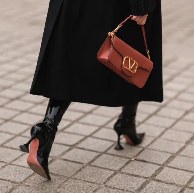 Neue water helps stay on the go. Valentino Bag and heels. Street style